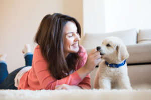 40899201 - woman lying on floor with a puppy